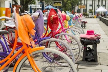 Obraz premium Colorful bicycles lined up for hire in Fatahilah Square in Jakarta's Old Town. Bicycling is popular among the visiting locals and tourists alike.