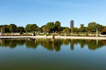 Color DSLR stock image of pond in Luxembourg Gardens with the Montparnesse Tower in the background. The Paris, France park is popular with residents and tourists. Horizontal with copy space for text