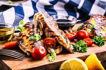 Grilled chicken breast in different variations with cherry tomatoes, .mushrooms, herbs, cut lemon...