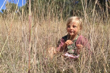 girl sitting in a field