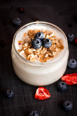 Healthy breakfast - yogurt with blueberries and muesli served in bank