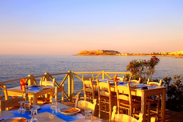 traditional greek outdoor restaurant on terrace at street village