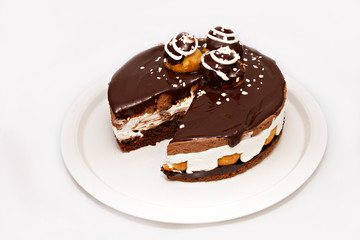 Chocolate cake with white topper on white plate