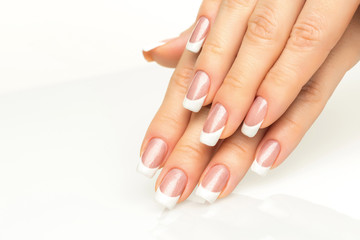 Woman hands with french manicure  close-up - obrazy, fototapety, plakaty