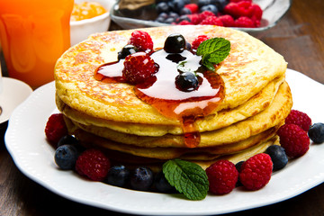 Pancakes with berries and maple syrup