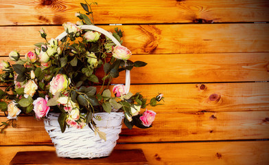 Beautiful artificial roses in a wicker basket - Powered by Adobe