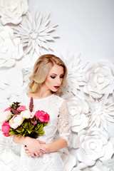 Young gorgeous woman, bride, blond long curly hair, studio decor