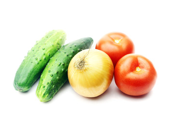 Vegetables - tomato, a cucumber and onions on a white background