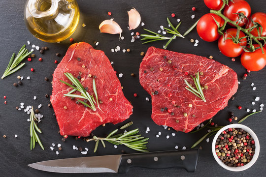 raw steak with cooking ingridients