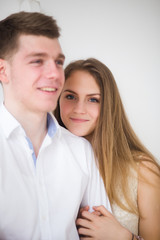 Happy woman dressed in  shirt put her head on shoulder of man