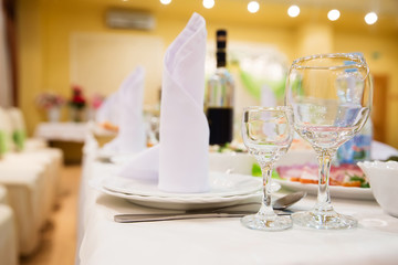 Restaurant table with glasses, napkins and cutlery