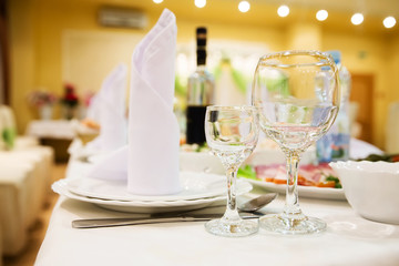 Restaurant table with glasses, napkins and cutlery