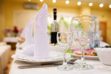 Restaurant table with glasses, napkins and cutlery