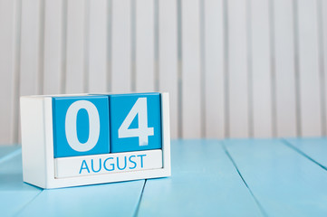 August 4th. Image of august 4 wooden color calendar on blue background. Summer day. Empty space for...