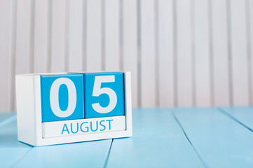 August 5th. Image of august 5 wooden color calendar on blue background. Summer day. Empty space for text. International Beer Day