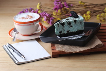 notebook pen and coffee cup with cake and cookie