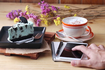 notebook pen and coffee cup with cake and cookie