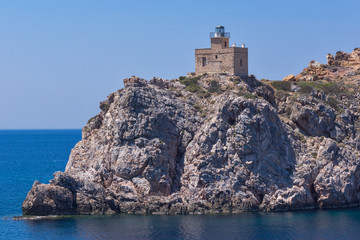 Fototapeta na wymiar Amazing Seascape of Lighthouse of port of Ios island, Cyclades, Greece