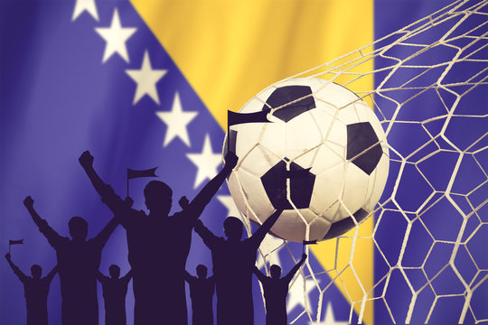 silhouettes of Soccer fans with flag of Bosnia and Herzegovina.C
