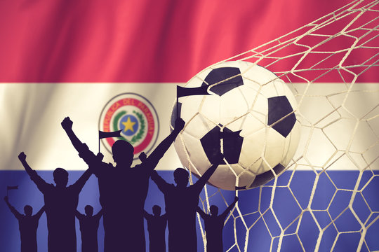 silhouettes of Soccer fans with flag of Paraguay .Cheer Concept