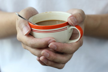 two hand hold warm coffee cup