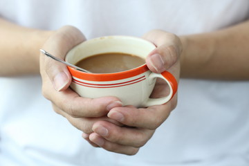 two hand hold warm coffee cup, closeup