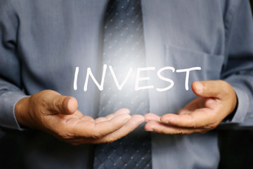 Invest word on hand, businessman