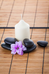 Spa concept: zen stones, candles and flowers