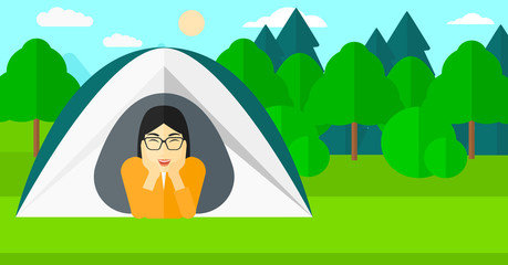 Woman lying in tent.