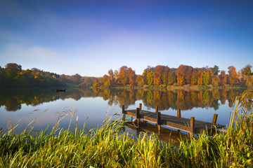 Fototapeta premium Still waters of a lake in autumn