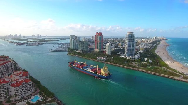 Aerial video of a cargo ship entering Port Miami through Government Cut