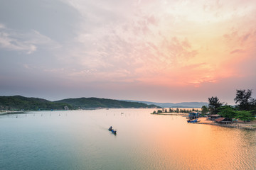 Alone boat in O Loan lagoon at sunset