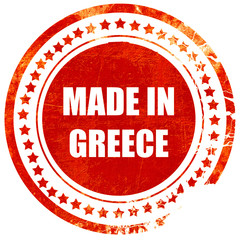Made in greece, grunge red rubber stamp on a solid white backgro