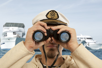 Captain looks through a binoculars