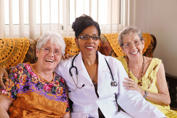 Portrait Of Doctor And Happy Old People In Hospice