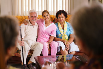 Portrait Of Nurse And Happy Old People In Hospice