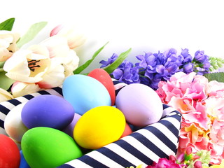 colorful easter eggs with spring flowers background