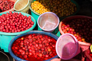 Pickled vegetables, fruits in buckets at market, Myanmar