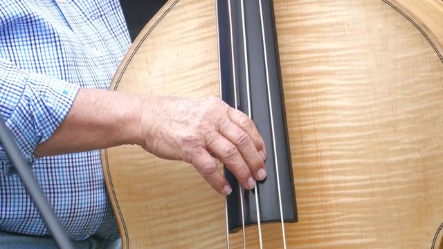Base Fiddle Strings Being Played 