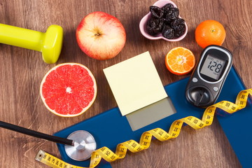 Electronic bathroom scale and glucometer with result of measurement, healthy food and dumbbells, healthy lifestyles, diabetes and slimming concept