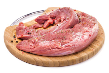 Pork tenderloin on a cutting board with ingredients