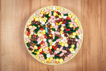 Medical tablets or supplements on plate, health care and slimming concept