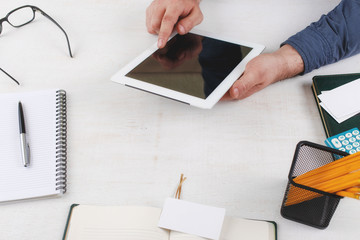 Man clicks on a blank screen tablet computer