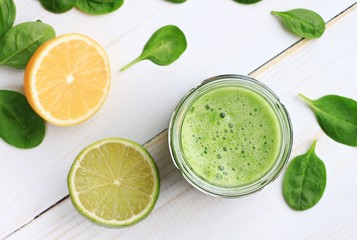 Green fresh smoothie drink - spinach and lime. Top view. Soft focus.