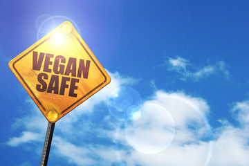 Yellow road sign with a blue sky and white clouds: vegan safe