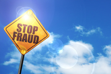 Yellow road sign with a blue sky and white clouds: stop fraud