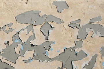 Old cracked gray paint on a wall surface . background texture