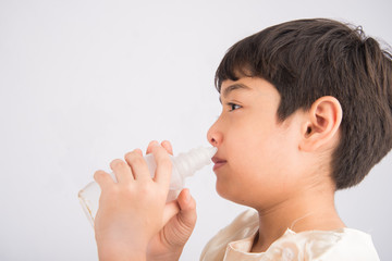 Little boy using salt water to clean his nose