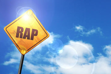 Yellow road sign with a blue sky and white clouds: rap music