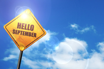 Yellow road sign with a blue sky and white clouds: hello septemb